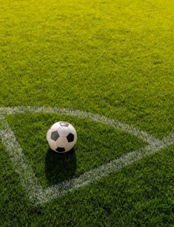 soccer ball on grass in corner kick position